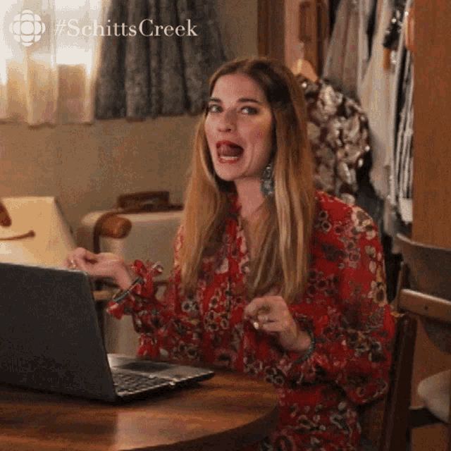 Animated image of Alexis Rose from Schitt's Creek flipping her hair back and forth